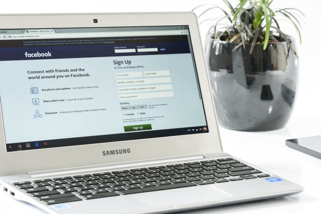 Pay Per Click (PPC) Ads card: computer with Facebook open